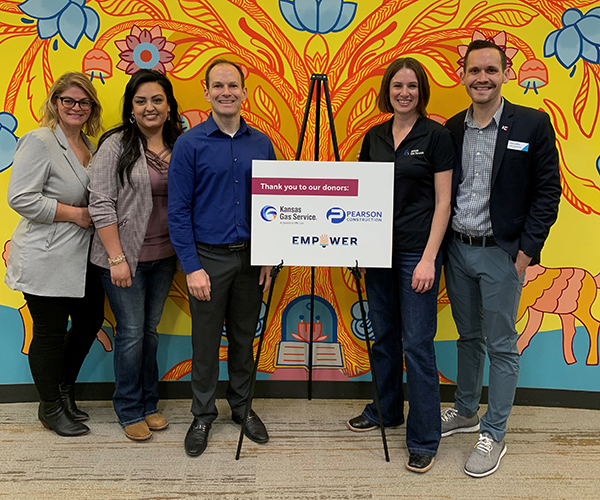 group of people standing with sign